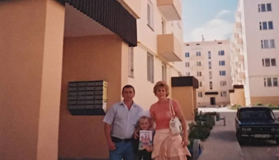 Тетяна Шевчук з родиною біля будинку, в якому 2007 року отримала квартиру від України